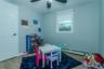 Recreation room with wood-type flooring, ceiling fan, and a baseboard heating unit