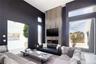 Living room featuring a towering ceiling and a fireplace