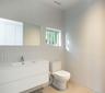 Bathroom featuring tile walls, vanity, and light tile patterned flooring