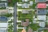 Expansive 60 x 100 lot featuring a single-family residence, mature trees, and a spacious green lawn
