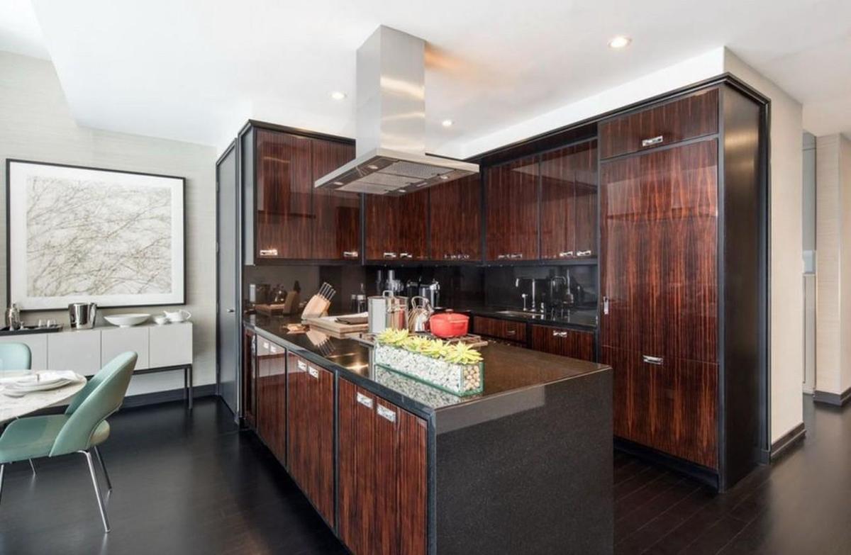 Kitchen featuring dark hardwood / wood-style floors, sink, island range hood, and dark brown cabinetry