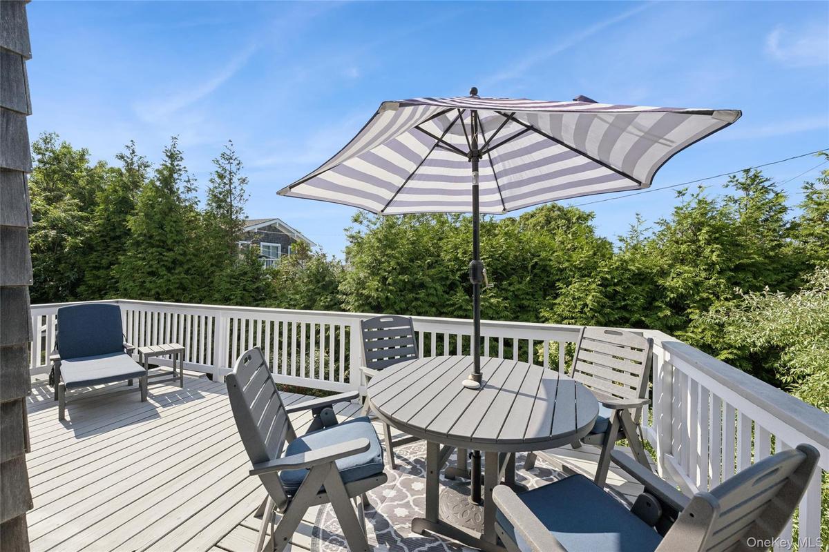 Spacious outdoor deck featuring light-toned decking and a white railing system