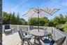 Spacious outdoor deck featuring light-toned decking and a white railing system