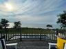 Deck featuring a water view and a lawn