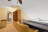 Home office with a ceiling fan, light wood-style floors, and lofted ceiling
