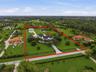 Pristine 5 Acre Lot- Main house, Workshop, RV Barn & Lake- close to shopping, restaurants, & I-75