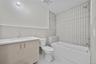 Bathroom featuring vanity, tile walls, tub / shower combination, and tile patterned floors