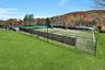 View of two artificial grass lighted tennis courts.  Six tennis courts in total.