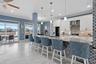 Kitchen has custom backsplash and a stone accent wall. This Chefs kitchen has been completely remodeled with new white shaker cabinets, a large breakf
