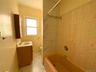 Full bathroom with bathtub / shower combination, vanity, and light marble finish flooring