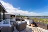 View of rooftop terrace with an outdoor kitchen and a water view