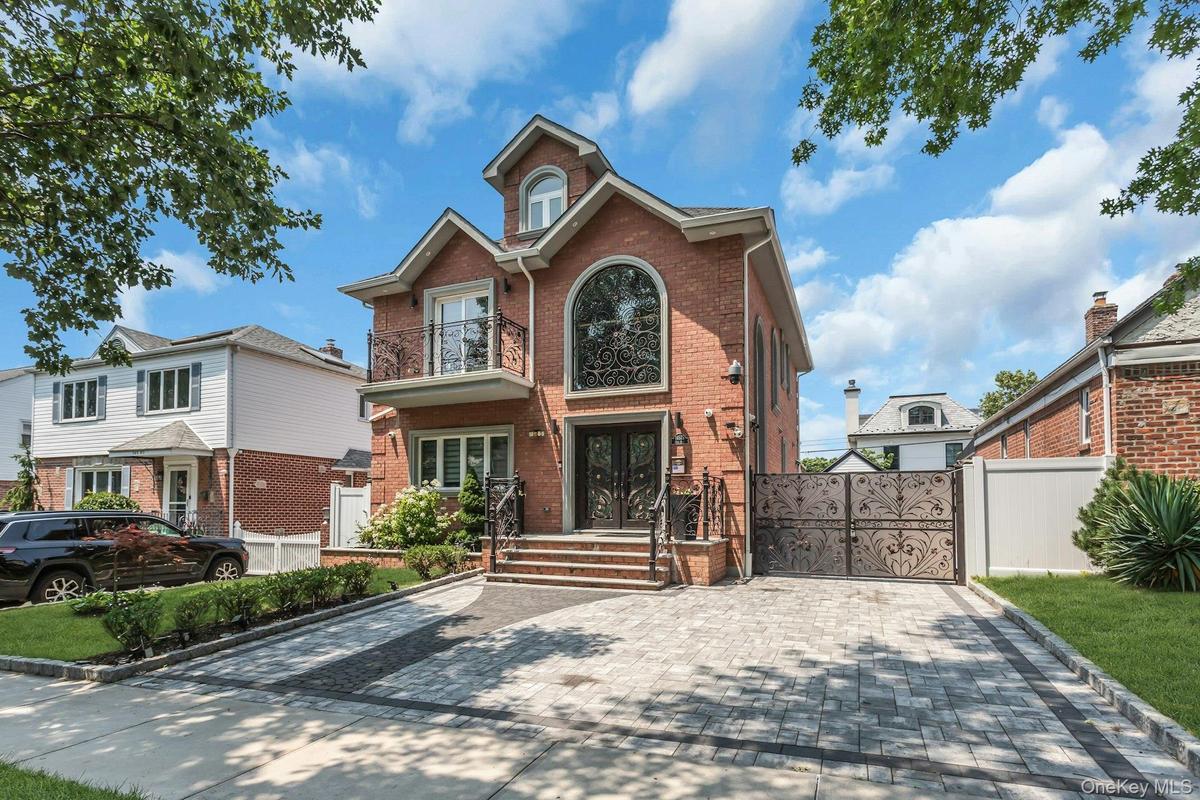 Featuring a full 2-car paver driveway, and professionally manicured landscaping wth inground sprinklers