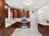 Kitchen featuring stainless steel appliances, light quartz counters,