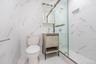 Bathroom featuring vanity, a marble finish shower, and marble finish flooring