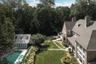 Aerial view of property and surrounding area featuring a pool