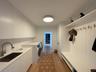 Washroom with a sink, light wood-style flooring, cabinet space, and washing machine and dryer