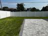 Fenced backyard with a patio
