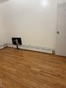 Empty room featuring light wood-type flooring and baseboard heating