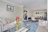 Living room with stairs, a chandelier, crown molding, recessed lighting, and carpet floors