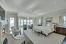 Bedroom featuring dark wood-style floors, crown molding, and a lit fireplace