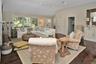 Living room with dark wood finished floors, vaulted ceiling, and recessed lighting