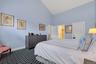 Bedroom featuring high vaulted ceiling and dark carpet