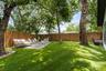 Paver Seating Area, Artificial Turf. Mature Landscaping. Wood Fenced-In an Lower Iron Fence . Artificial Turf Vacuum Conveys in the sale of the home.
