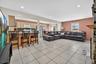 Living area featuring recessed lighting and light tile patterned floors