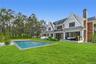 Rear view of house featuring a yard, a chimney, a patio area, an outdoor hangout area, and an outdoor pool