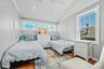 Vaulted wood-plank ceiling with recessed lighting and ceiling fan