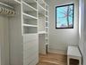 Walk in closet with wood finished floors