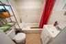 Full bathroom featuring tile walls, vanity, shower / tub combo with curtain, and tile patterned floors