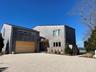 Modern home featuring gravel driveway