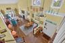 Living area featuring a high ceiling, wood-type flooring, and a fireplace
