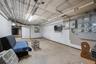 Unfinished below grade area featuring electric panel