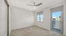 2nd bedroom which has a private balcony and large window, light and bright room