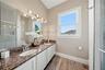 This dual sink bathroom is spacious and is between the second and third bedroom