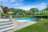 Swimming pool featuring a yard, a deck, and a patio