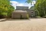 View of front of home featuring driveway, a garage, and a shingled roof