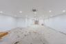 Empty room with cooling unit and recessed lighting