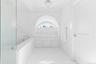 Bathroom with a bath and crown molding
