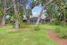 Great view of back side of home through the trees.