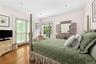 Bedroom featuring crown molding, wood finished floors, and access to exterior