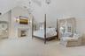Luxurious primary suite featuring generous proportions, abundant natural light, and a serene, private ambiance.