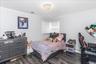 Room featuring wood-finish flooring, white walls, and crown molding