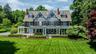 Open porches, gables, 5 fireplaces enveloped by mature plantings and trees