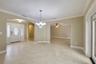 Step through the ELEGANT ETCHED GLASS FRONT DOOR and into a home where crown molding and tile flooring flow throughout—with no carpet to be found.
