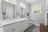 Large Primary Ensuite Bathroom with a double vanity and a large walk-in shower with frameless glass door and rainfall showerhead