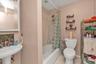 Bathroom with tile patterned floors and shower / tub combo