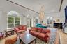 Living room with a chandelier, recessed lighting, crown molding, and light tile patterned floors